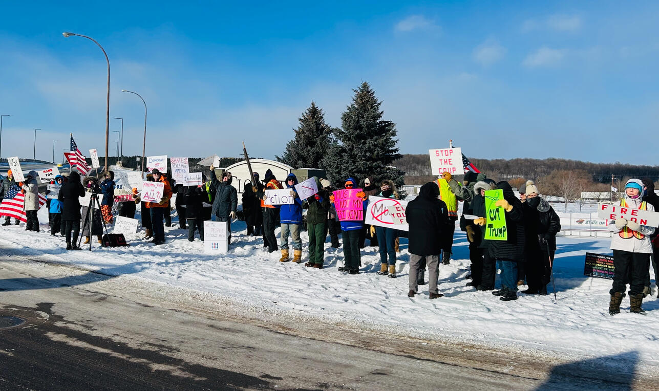 Protest participants holding advocacy signs during the 2025 President's Day demonstration in Cloquet, Minnesota